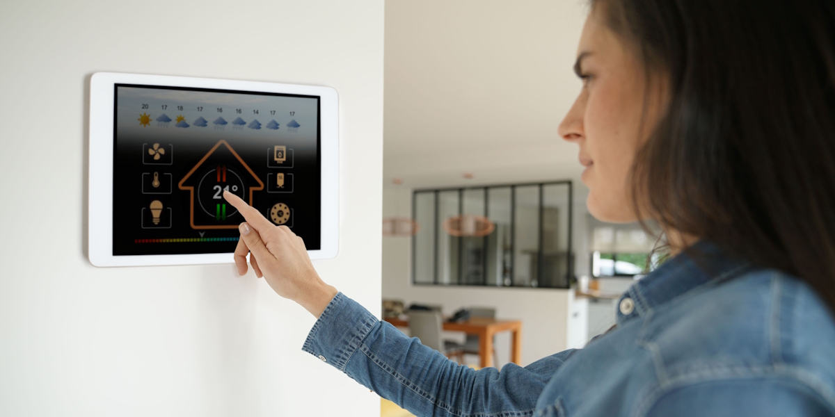 Woman,Using,Smart,Wall,Home,Control,System